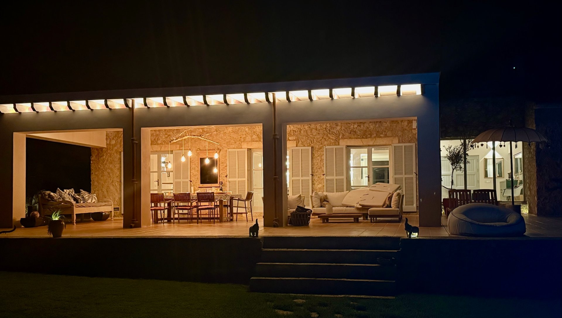 Finca at night with warm terrace lighting